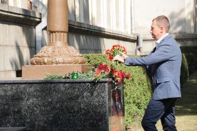 People carry flowers to the walls of the Kharkiv National University of the Air Force named after Kozhedub