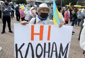 Woman in medical mask holding a poster