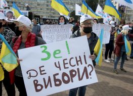 Protesters hold posters