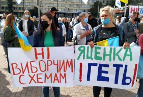 Protesters hold posters