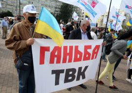 Protesters hold posters