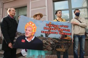 Picket participants hold a poster