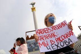 The participant of the action holds a poster