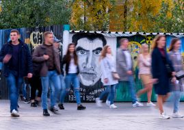 Passers-by near the image of Vasily Stus