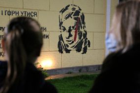 A mural with a portrait of activist Kateryna Gandziuk and a quote from her speech