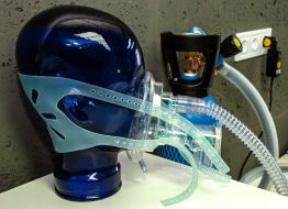 Apparatus for non-invasive artificial lung ventilation