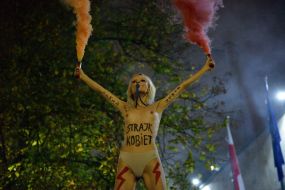 Femen activist with a fireworks display