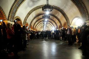 Passengers take photos of lights at the Golden Gate metro station