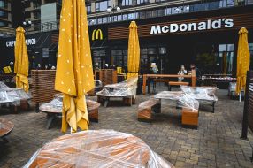 People stand in line at the window of "McExpress" in the fast food restaurant "McDonalds"