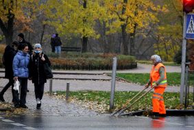 A utility worker cleans the water intake grilles