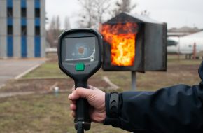 A lifeguard holds a thermal imager