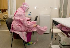 The doctor wears a protective suit