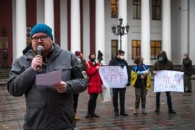 Protesters hold posters