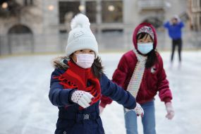 Children in respiratory masks on the ice rink in Lviv