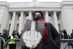 The participant of the action holds a poster