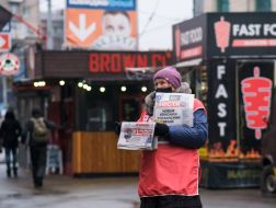 Woman with Vesti newspapers