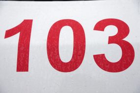 The inscription "103" on the ambulance