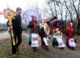 A group of carolers with a Christmas star