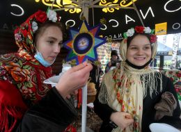 A group of carolers with a Christmas star