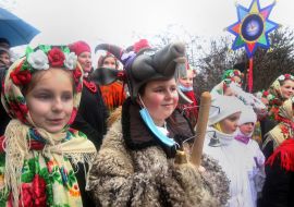 A group of carolers with a Christmas star