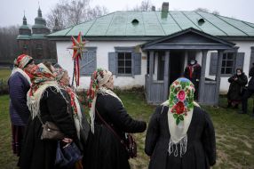 A group of carolers with a Christmas star