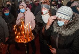 Parishioners light candles