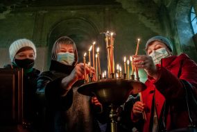 Parishioners light candles