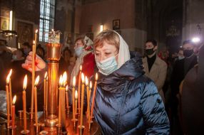 The parishioner lights a candle