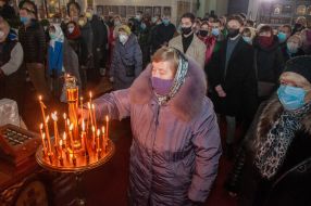 The parishioner lights a candle