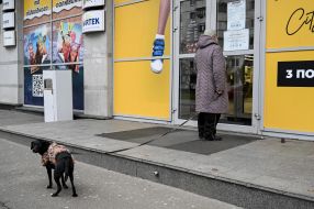 Woman at the closed door of one of the shops in Kiev