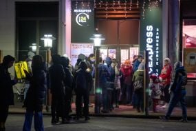 People stand in line at the window of "McExpress" in the fast food restaurant "McDonalds"