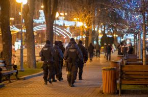 Law enforcement officers are patrolling a street in Kyiv