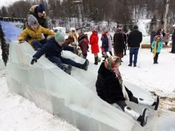 Children ride on an ice slide