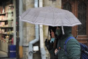 Passers-by with an umbrella on the street in Lviv