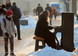 A man plays the piano on the street