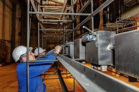 Electricians are replacing the lighting equipment of the big stage