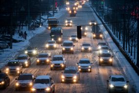 Автомобили едут по заснеженной дороге