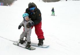 A boy learning to snowboard