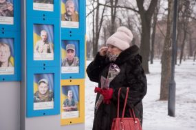 People near the memorial to the defenders of Ukraine