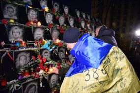Participants of the March of Remembrance of the Heroes of the Heavenly Hundred near the portraits of the heroes of the Heavenly Hundred