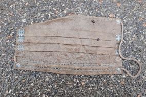 The medical mask lies on the asphalt