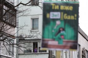 The woman takes pictures of the protesters on her mobile phone