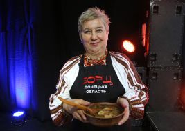 Woman holding a bowl of borscht