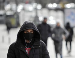 A passerby in a protective mask
