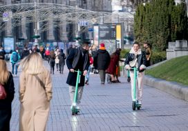 Young people ride electric scooters