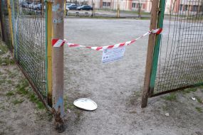 Tape fencing at the entrance to the football field