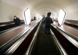 Passengers ride on escalators in the subway