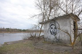 Drawing of a woman on the wall of a building in Chernobyl