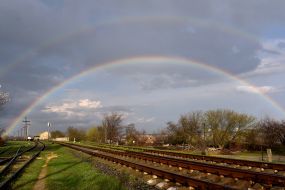 Rainbow in the sky over the railway tracks