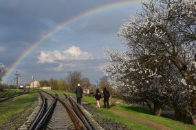 Rainbow in the sky over the railway tracks